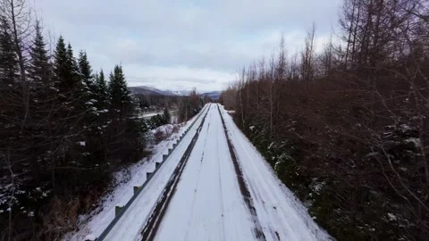 Winter Road Through Forest – Aerial FPV Flyover Stock Footage 321659596