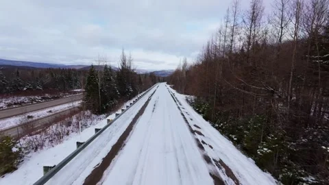 Winter Road Through Forest – Aerial FPV Flyover Stock Footage 321659606
