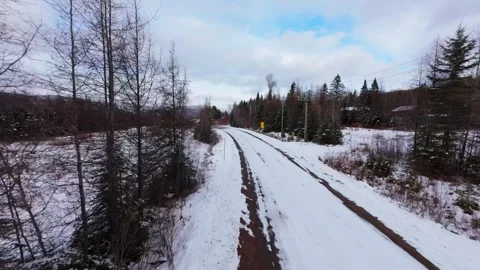 Winter Road Through Forest – Aerial FPV Flyover Stock Footage 321659672