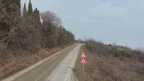 Winter Road Through Forest With Warning Traffic Sign Stock Footage 328822856