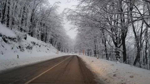 Winter road through the mountain Stock Photos