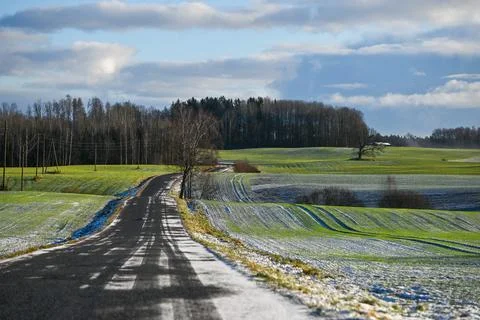 Winter Road Through Rolling Fields in Latvia Stock Photos