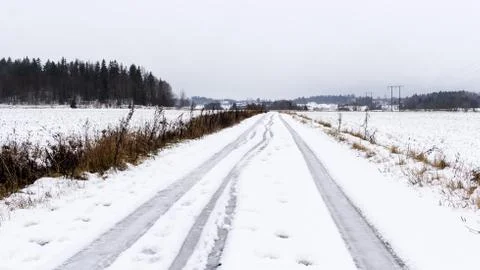 Winter road through snow fields Stock Photos