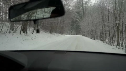 Winter road through snowy  forests. Car driving on snow road Stock Footage 148082653