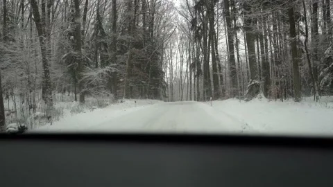 Winter road through snowy  forests. Car driving on snow road Stock Footage 148082751