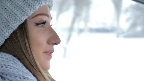 Winter road trip. Profile of a young beautiful girl driver, a young blonde Stock Footage 162889519