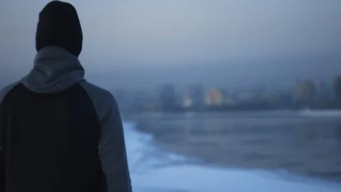 Winter runner Athlete on the river bank watch on Sunset city. Motivation concept Stock Footage 102323497