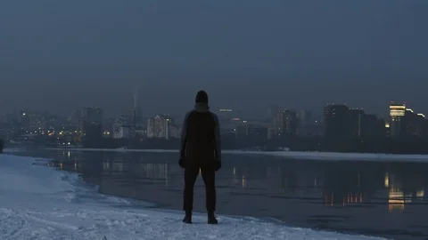 Winter runner Athlete on the river bank watch on Sunset city. Freedom concept Stock Footage 102455017