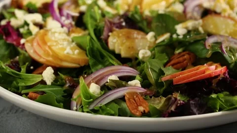 Winter salad with apple, red onion and pecans with dressing Stock Footage 242526011