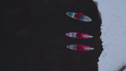 Winter sapboarding, people sailing on a sapboard Stock Footage 324919341