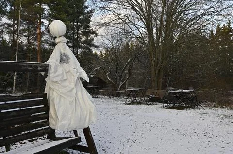 A winter scene in an outdoor setting featuring a rustic bench adorned with .. Stock Photos