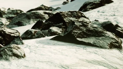 Winter scene with snow covering large rocks by the water Stock Footage 339868814