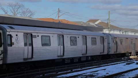 Winter scene unfolds at the bustling train station during a chilly afternoon 库存影片 291513400