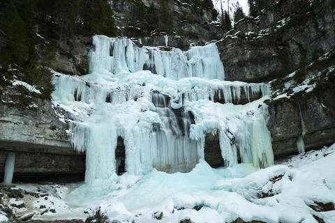 Winter Scenery inside the frozen waterfall. Sharp details: clear ice. Stock Photos