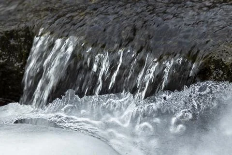 Winter Scenery inside the frozen waterfall. Sharp details: clear ice. Stock Photos