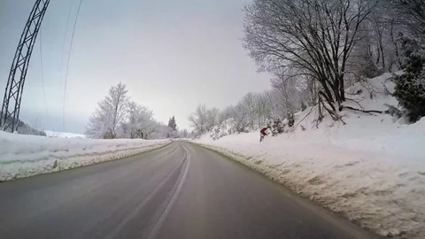 Winter scenery snow vehicle drive POV countryside hilly cloudy sky trees car Stock Footage