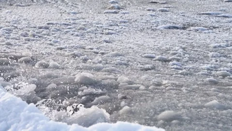 Winter sea close-up of slush ice breaking with splashing waves under soft d.. 動画素材 331203367
