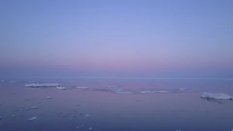 Winter sea with floating ice at sunset Stock Footage 304028786