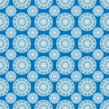 Winter seamless pattern with white snowflakes on blue background. Vector Stock Illustration
