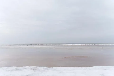 Winter seascape in the middle of a cloudy day. Baltic sea, Jurmala, Latvia Stock Photos