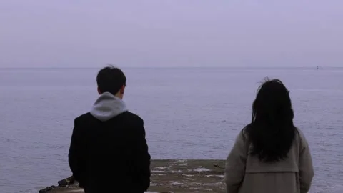 Winter seaside, a couple's back view 動画素材 249900452