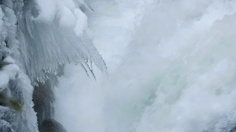 Winter Season Elements of Nature with Icicles Hanging Over Waterfall Stock Footage 304970311