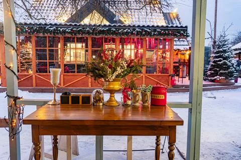 Winter setting, snow-covered ground with an old wooden table in foreground .. 스톡 사진
