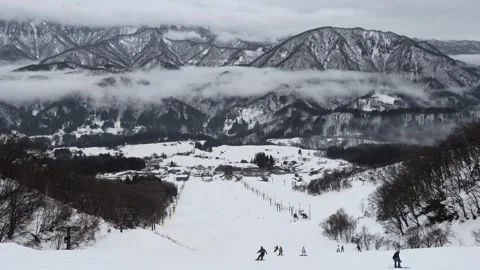 Winter Ski Resort Landscape with Low Clouds and Snowy Peaks Stock Footage 329767203