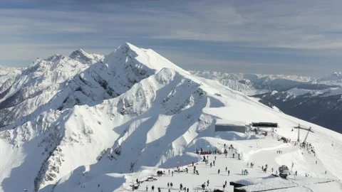 Winter ski resort Rosa Khutor in Sochi city. Snowy slope Rose Peak with ski Stock Footage 146741853