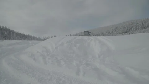 Winter Small Snowcat Drives Along  Path Paralell To Camera Stock Footage 154071192