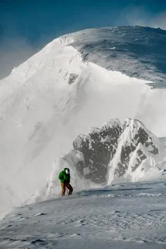Winter snow-covered mountain range and the male climber on it Stock-Fotos