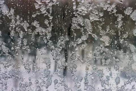 Winter snow-covered window close-up in cloudy weather. 写真素材