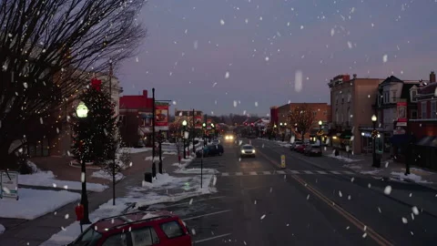 Winter snow flakes fall from sky. Christmas holiday decorations line Stock Footage 157080440