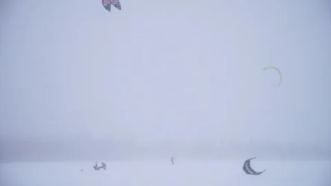 Winter snow kiting on the winter field. Snowfall Stock Footage 86996045