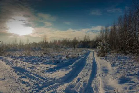 Winter snow landscape in the rays of the setting sun on December day. Stock Photos