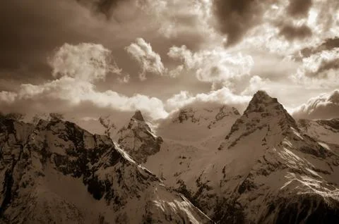Winter snow mountains in clouds Stock Photos
