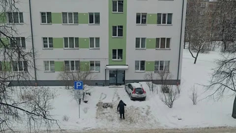 Winter Snow Removal In Riga - Worker Clears Renovated Apartment Building Vídeos de archivo 346092929