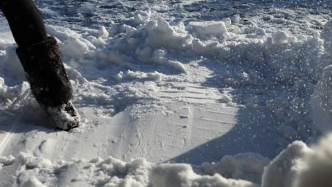 Winter snow removal showing diligent woman clearing snow covered path with Stock Footage 300666186