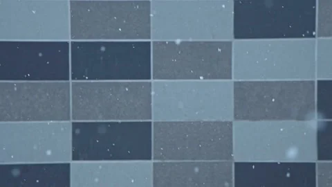 Winter snow is slowly falling against the background of gray construction tiles. Stock Footage 197064632