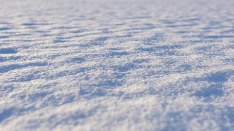 Winter snow surface with shiny snowflakes under sunlight. Close-up view. Foto stock