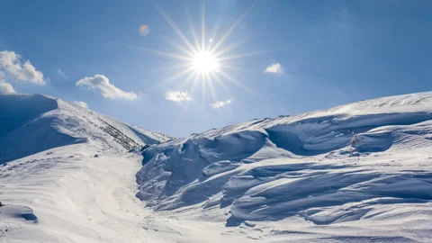 Winter snowbound mountains under a sparkle sun Stock Footage 320620444