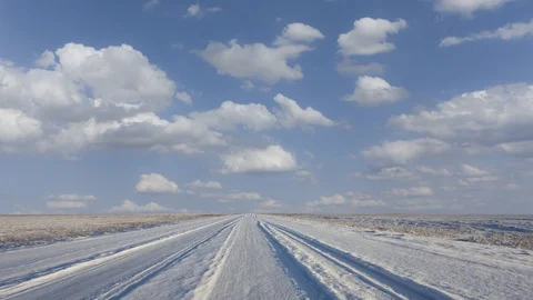 Winter snowbound plain under a cloudy sky Stock Footage 125471669