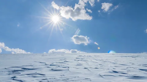 Winter snowbound plain under a sparkle sun time lapse scene Video stock 289620761