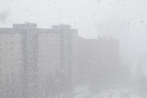 Winter snowfall against the background of a multi-storey residential buildi.. Stock Photos