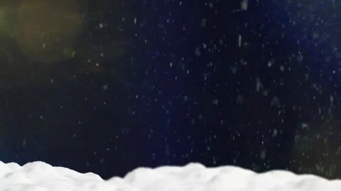 Winter snowfall falling over snowy ground landscape featuring soft golden lens Video stock 343843301