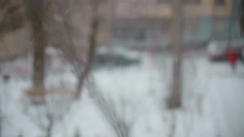 Winter snowfall outside the window, blurry view from the window Stock Footage 148532009