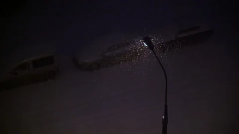 Winter snowfall under the light of a street lamp. Stock Footage 144723837
