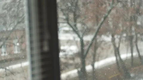 Winter snowfall view from house window. Cold snowy christmas weather Stock Footage 236695666