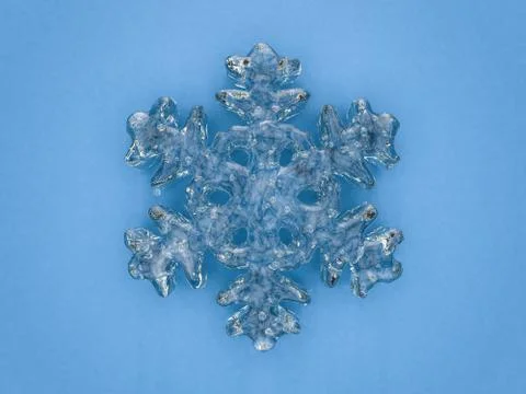 Winter snowflake on color background. 3D Stock Illustration