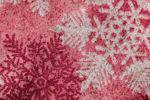 Winter snowflake pattern on red toned fabric Stock Photos